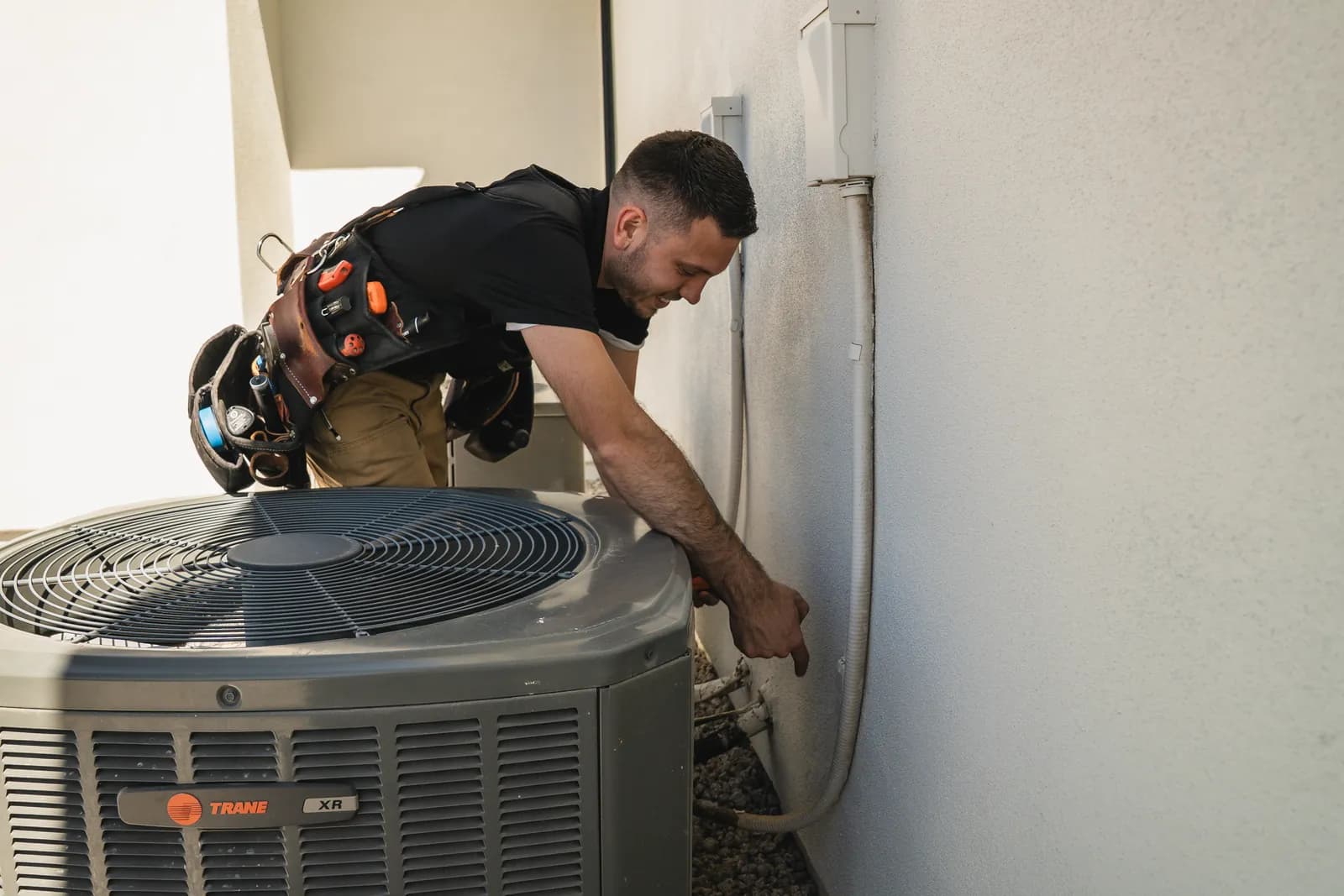 Good Faith inspector checking an air conditioning unit at an Arizona home